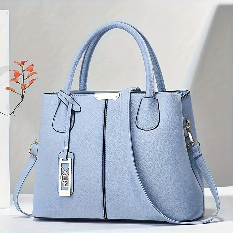 Women's stylish leather handbag with tote design, detachable crossbody strap, gold accents, spacious interior, elegant look.