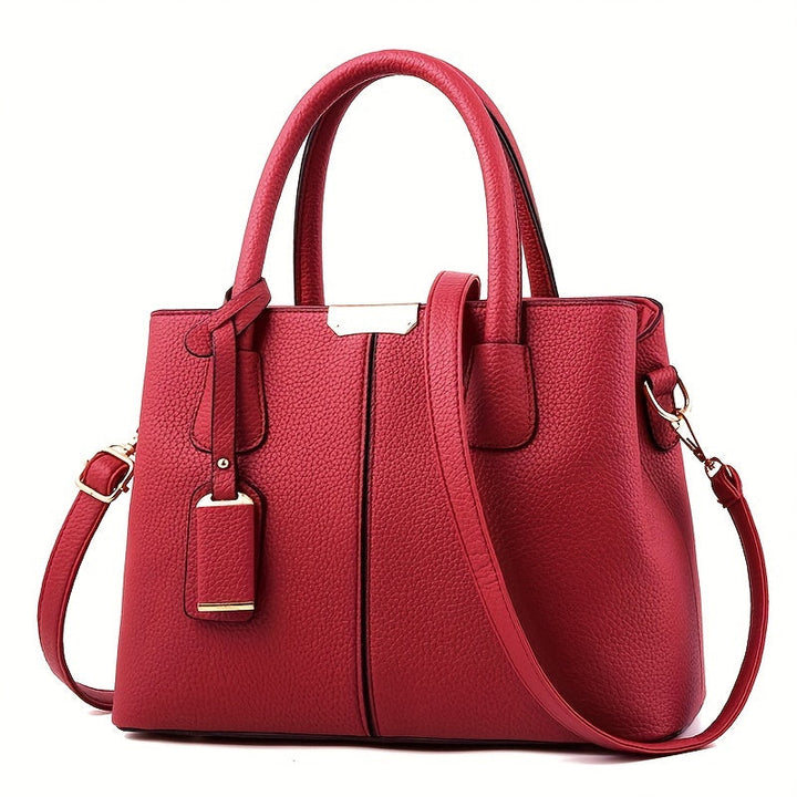 Women's stylish leather handbag with tote design, detachable crossbody strap, gold accents, spacious interior, elegant look.