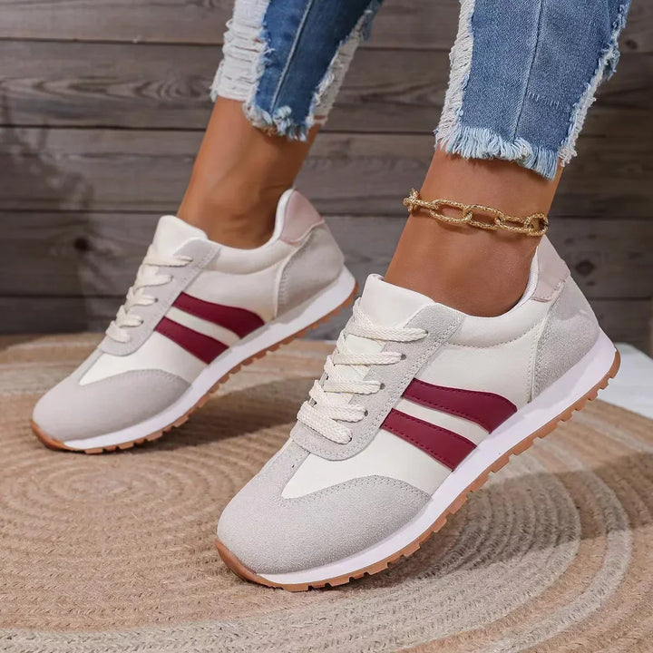 "Women's suede low top trainers with sleek suede upper, breathable fabric, and sporty side stripes for stylish comfort."
