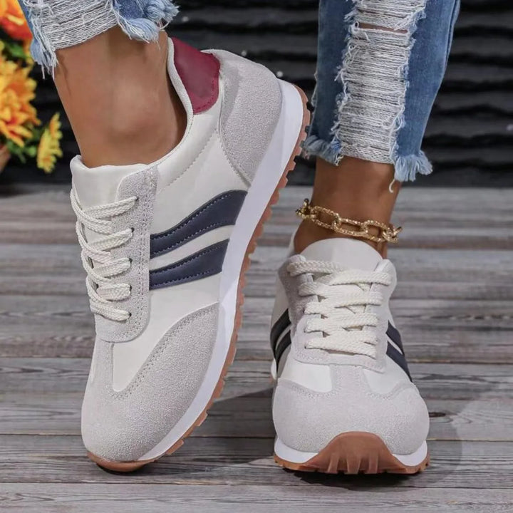 "Women's suede low top trainers with sleek suede upper, breathable fabric, and sporty side stripes for stylish comfort."