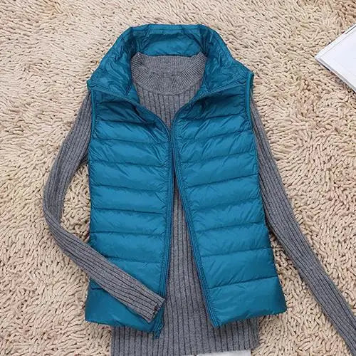 Women's ultra light down vest, warm, lightweight, sleeveless in sleek design, ideal for layering, perfect for chilly days.