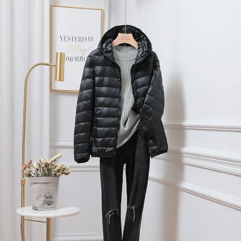 "Women's ultralight foldable puffer jacket with hood, chic design, lightweight, perfect for travel and cold weather."