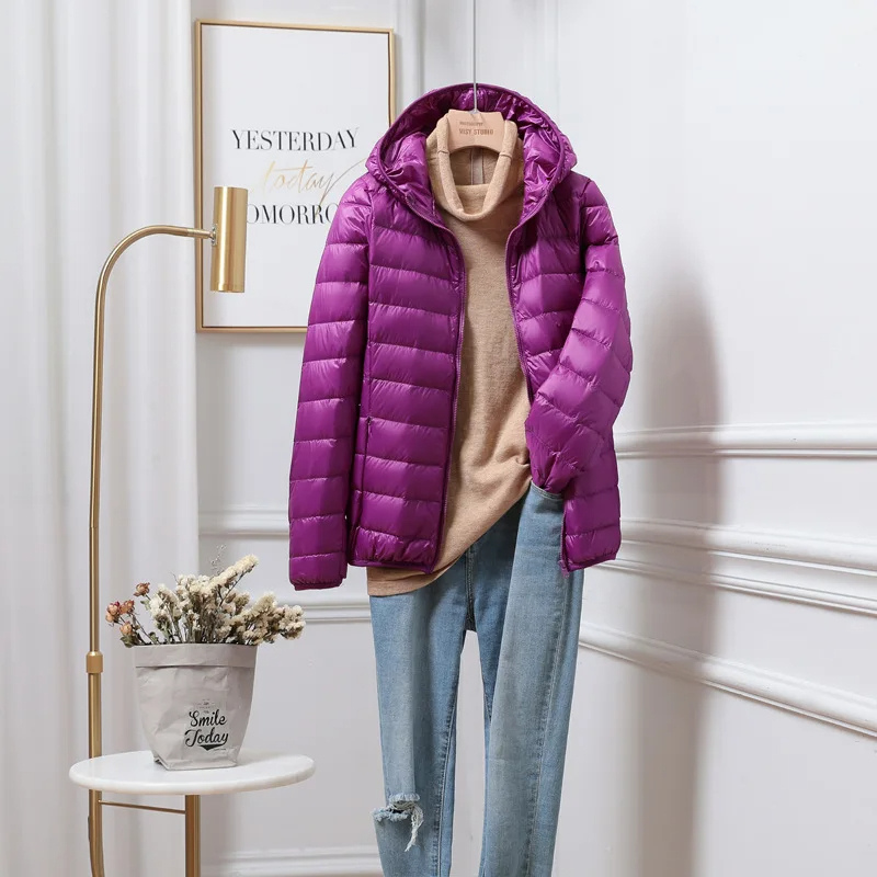 "Women's ultralight foldable puffer jacket with hood, chic design, lightweight, perfect for travel and cold weather."