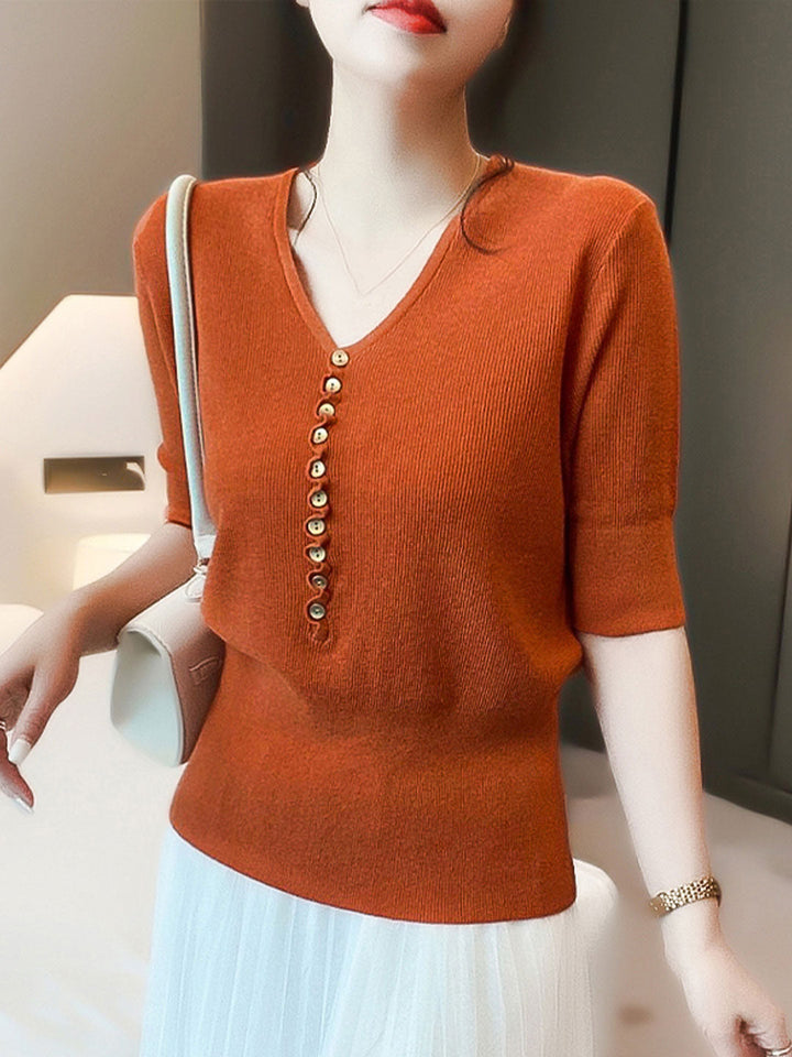 "Women's V-neck button knitted top with relaxed fit, shown in vibrant colors, offering style and comfort for any occasion."