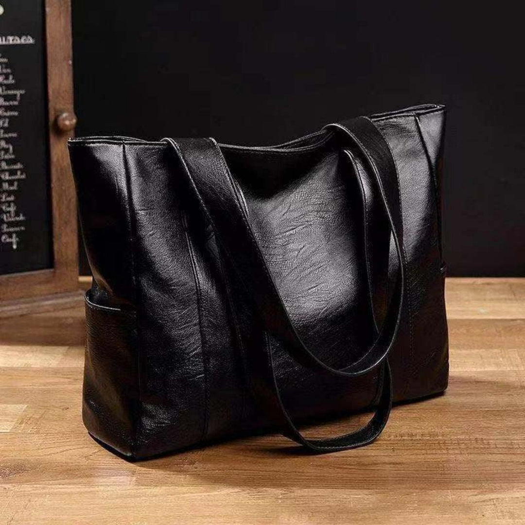 "Women's vintage leather shoulder bag, large capacity, sleek silhouette, elegant brown finish, perfect for daily use."