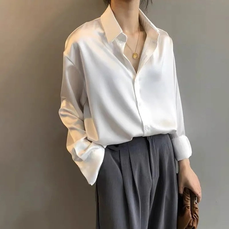 Women's vintage silk blouse with tailored fit, chic design, elegant silhouette, and luxurious lightweight fabric.