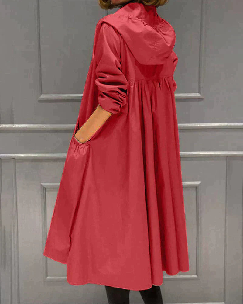 Women's waterproof hooded jacket in knee-length, relaxed fit, shown in lightweight fabric with ruched pockets for stylish cov
