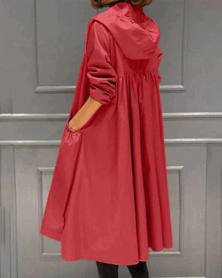 Women's waterproof hooded jacket in knee-length, relaxed fit, shown in lightweight fabric with ruched pockets for stylish cov
