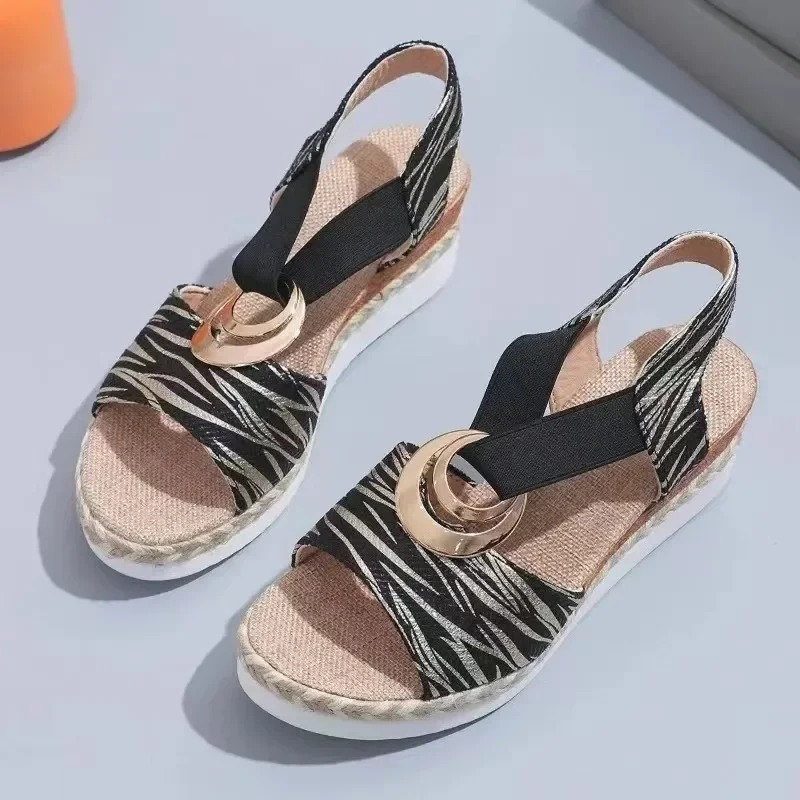 Women's wedge sandals with decorative ring, adjustable strap. Stylish, comfortable, and versatile footwear for any occasion.