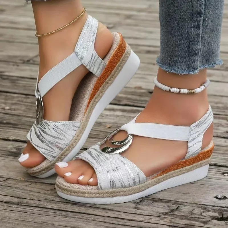 Women's wedge sandals with decorative ring, adjustable strap. Stylish, comfortable, and versatile footwear for any occasion.