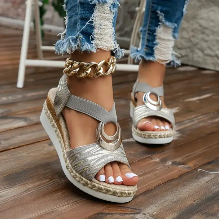 Women's wedge sandals with decorative ring, adjustable strap. Stylish, comfortable, and versatile footwear for any occasion.