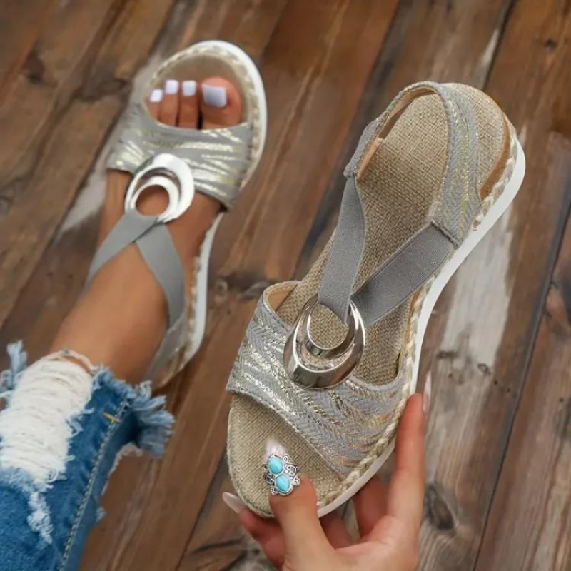 Women's wedge sandals with decorative ring, adjustable strap. Stylish, comfortable, and versatile footwear for any occasion.
