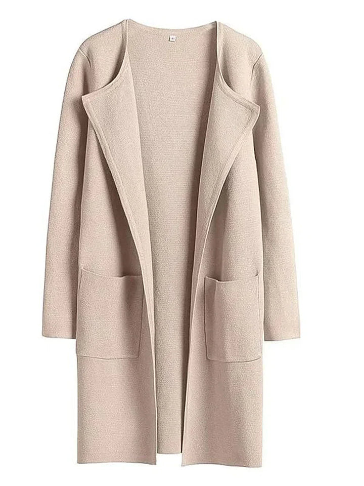 "Women's wool blend knee-length coat with wide lapel and patch pockets, showcasing a relaxed fit and minimalist design."