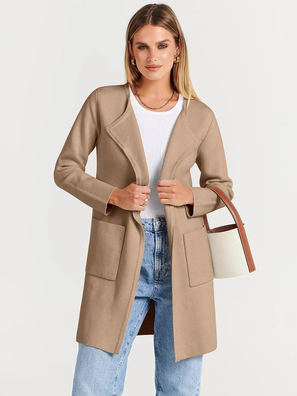 "Women's wool blend knee-length coat with wide lapel and patch pockets, showcasing a relaxed fit and minimalist design."