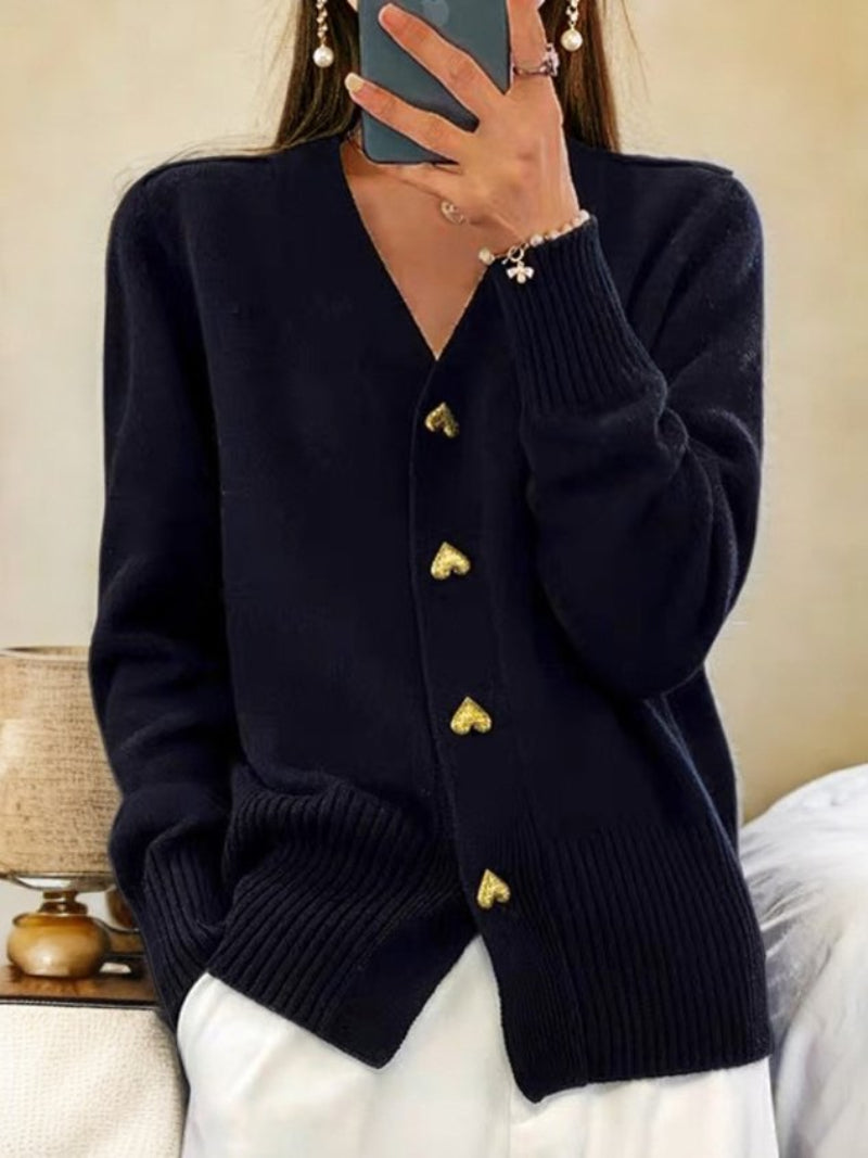 Women's wool cardigan in a solid color with button-up design, long sleeves, and hip-length perfect for winter warmth.