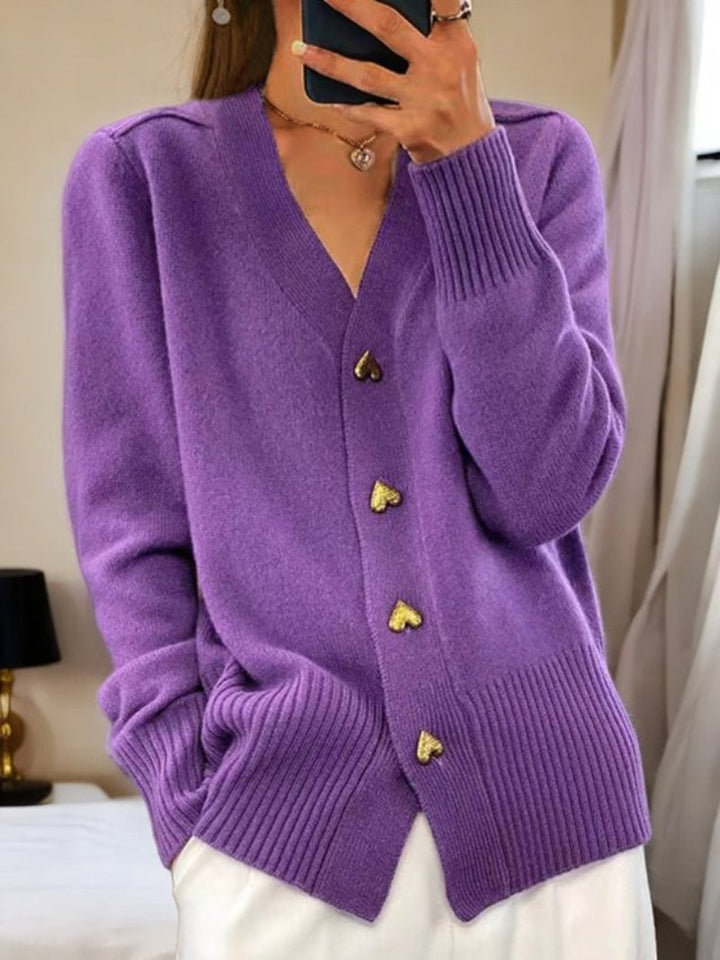 Women's wool cardigan in a solid color with button-up design, long sleeves, and hip-length perfect for winter warmth.