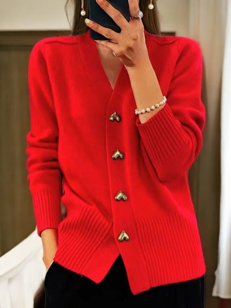 Women's wool cardigan in a solid color with button-up design, long sleeves, and hip-length perfect for winter warmth.