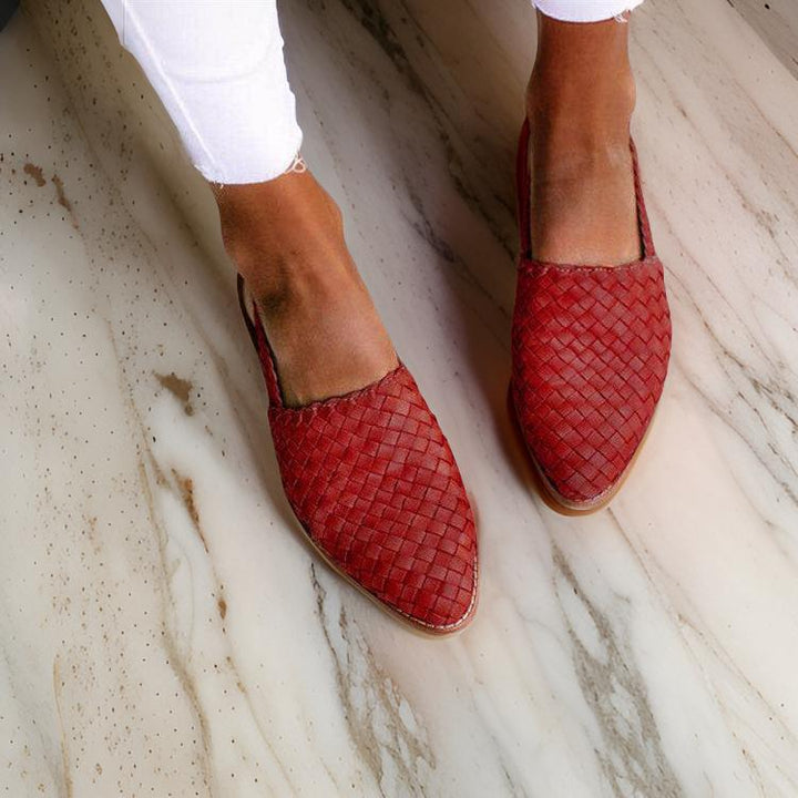 Women's woven leather sandals with slingback, featuring a hand-woven design and cushioned sole for all-day comfort.